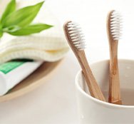 Aesthetic arrangement of toothbrushes in foreground and toothpaste in background